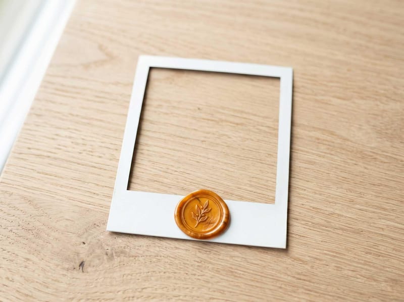 Blank polaroid frame with an amber wax seal on dark wood, representing a reviewed example marker.